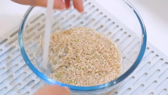 Rinse the brown rice thoroughly. The rinsing water will be less cloudy than with white rice.