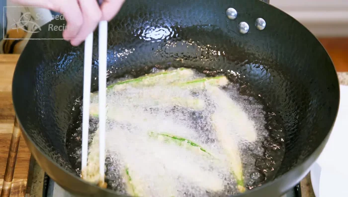 Remove okra from oil and drain on kitchen paper to absorb excess grease.