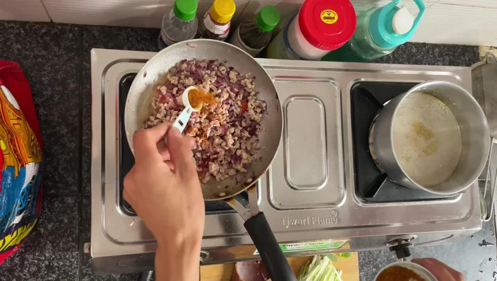 Add chopped tomatoes, chicken masala, Kashmiri chilli powder, turmeric, and salt to taste. Mix well and cook until chicken is fully cooked.