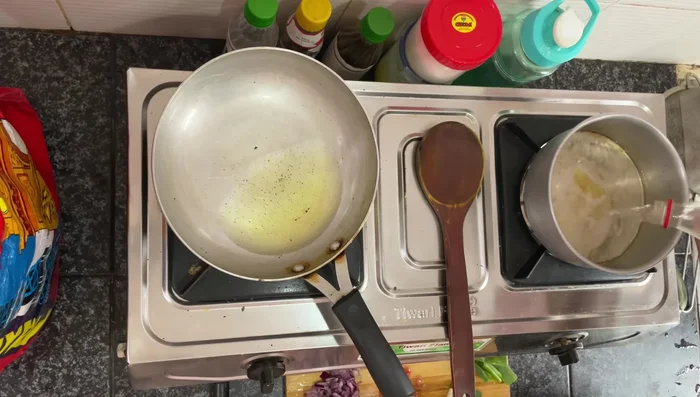 Heat oil in a pan. Add chopped onions (and optionally ginger and garlic) and fry until golden brown.
