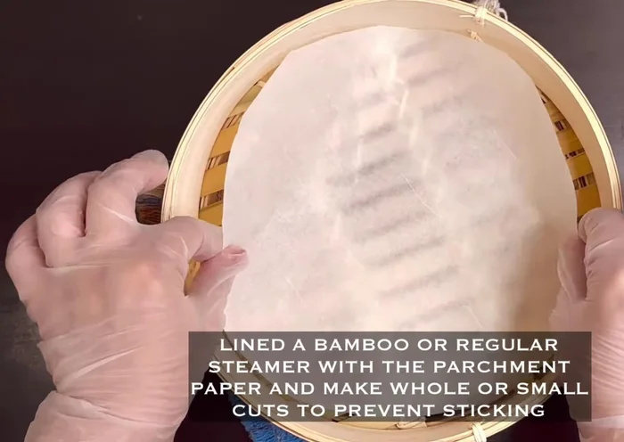 Line a bamboo steamer with parchment paper, making small cuts or holes to prevent sticking.