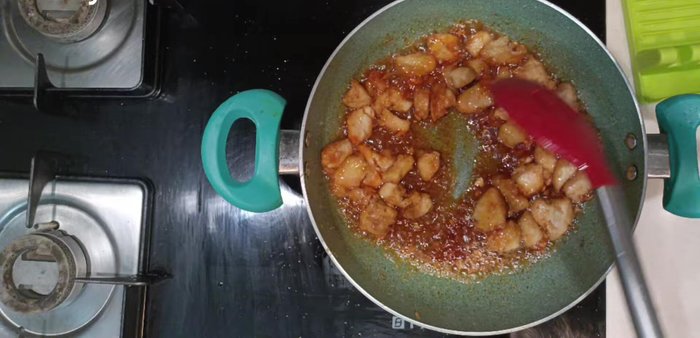 Add fried chicken and saute. Add vinegar, sugar, salt, pepper powder, and mix well. Add the red chili paste.