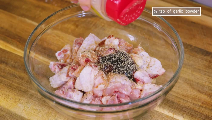 Marinate chicken with soy sauce, oyster sauce, pepper, garlic powder, sugar, cornstarch, and cooking oil.