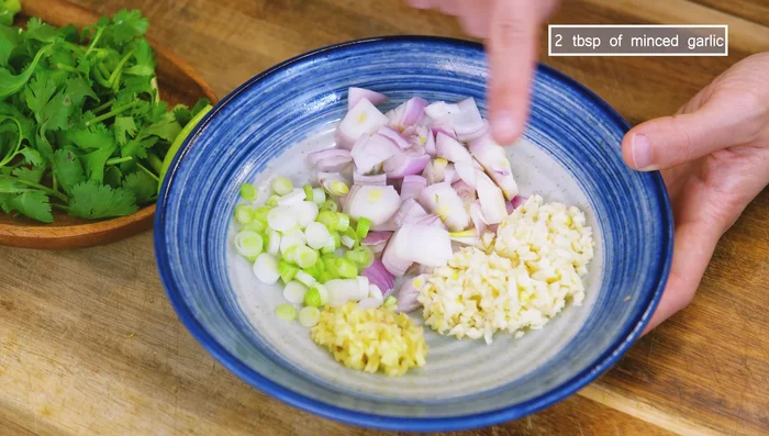 Prepare aromatics: dice shallot, mince garlic and ginger, chop scallions and cilantro.