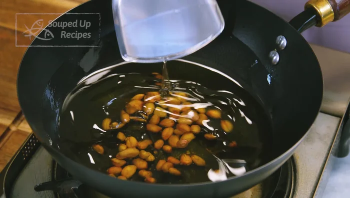 Fry peanuts in cold oil over medium heat until golden brown and crispy. Remove and set aside.