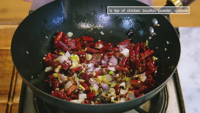 Add salt and optional chicken bouan powder. Return chicken to wok and stir until combined.