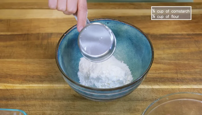 Combine cornstarch and flour. Coat chicken with half the mixture, then add marinated chicken and coat with remaining flour.