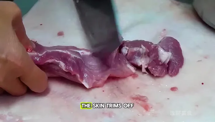 Prepare the jelly: Chop the trimmed pork fat into thin strips. The pork skin from the previous day is simmered to create a rich jelly, crucial for the dumpling's juiciness.