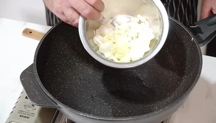 Add a little more oil to the pan and stir-fry garlic and onion (if using) for about 40 seconds until fragrant.