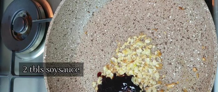 In the same pan, return the sautéed garlic (not the crispy one). Add oyster sauce, soy sauce, black pepper, sugar, vinegar, and water. Let it simmer.
