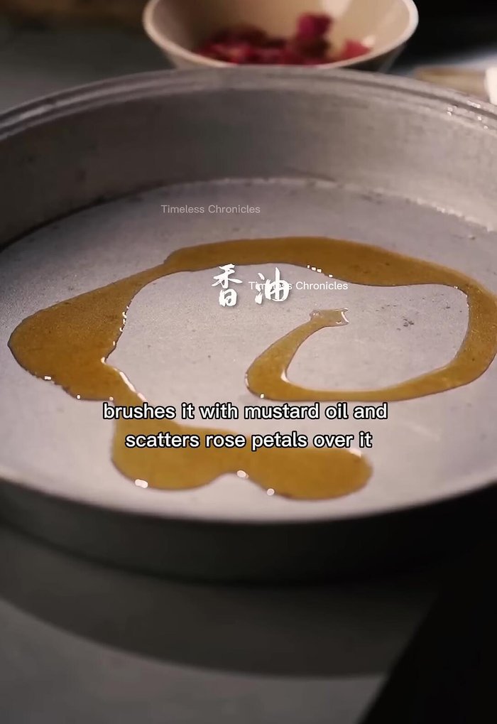 Brush a metal plate with mustard oil and scatter rose petals over it.