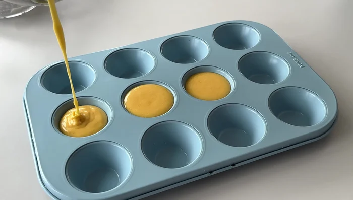 Pour batter into a greased muffin tin or cupcake mold, filling each cup about 2/3 full.