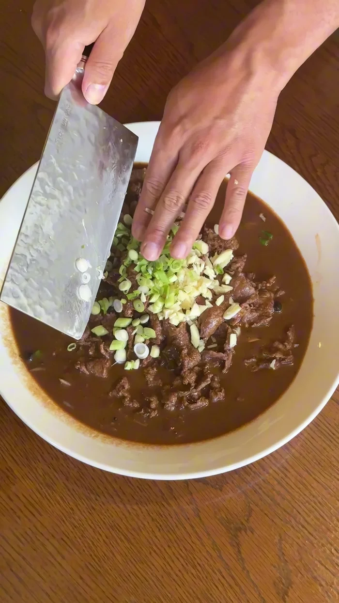 Prepare toppings: garlic, spring onions, chili flakes, and optional chili powder.
