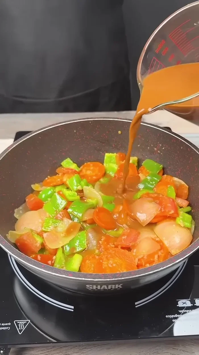 Add the sauce to the pan and mix well with the other ingredients. Cover and let it cook.