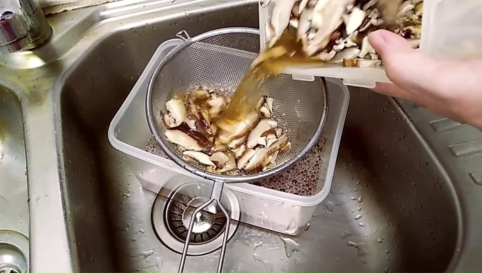 Drain and squeeze out excess water from the soaked mushrooms.