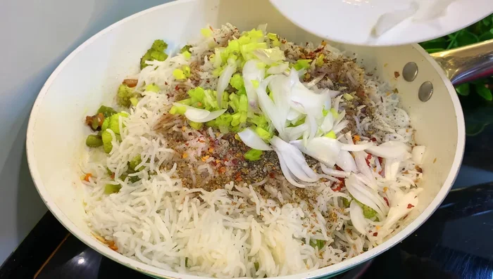 Add spring onion and sliced onions. Mix well.
