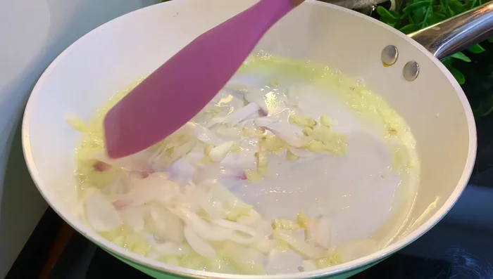 Add medium-sized onion slices and fry for a short time.