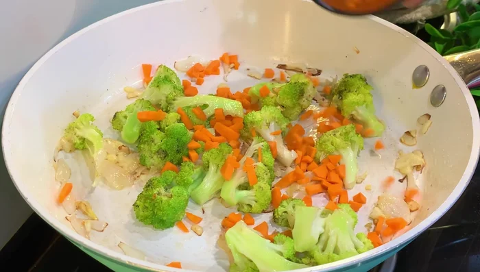 Add 1 cup of chopped carrots, 1 cup capsicum, and 1 cup beans. Mix well.