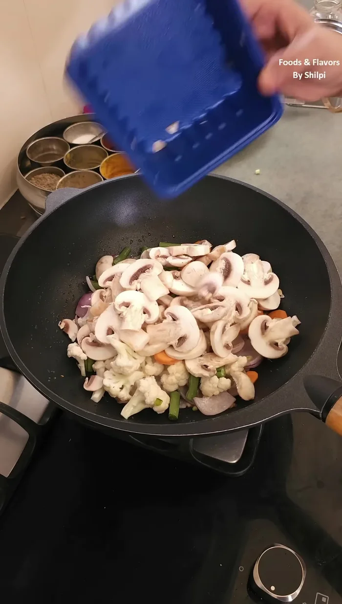 Add beans, carrots, cabbage, and mushrooms; fry a little. Add paneer and mix well.