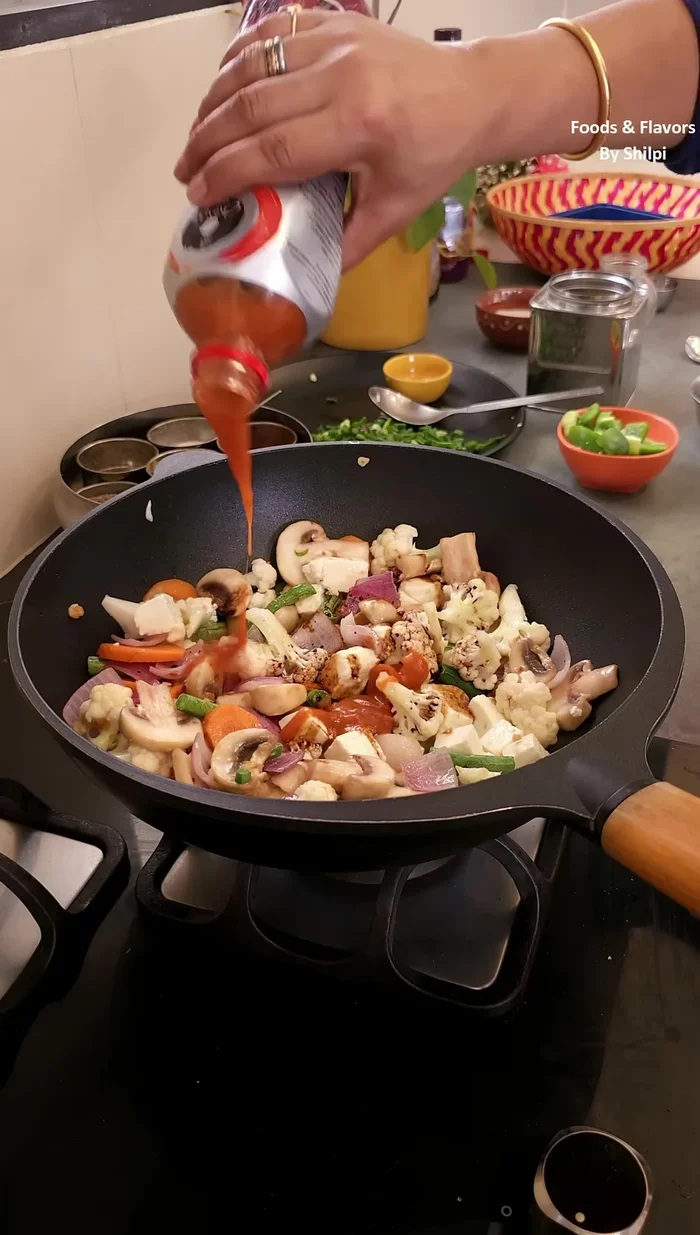 Add dark soy sauce, red chili sauce, green chili sauce, and a little black pepper powder. Mix well.