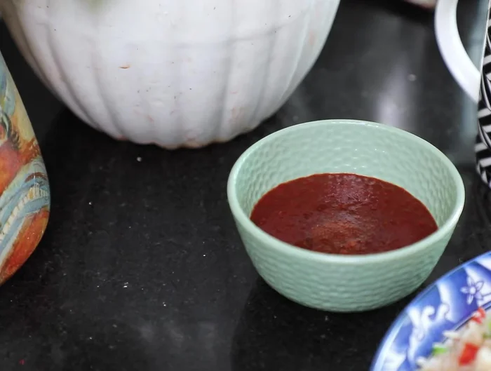 Add stock or water, Sichuan sauce, salt, pepper, and sugar. Stir well.