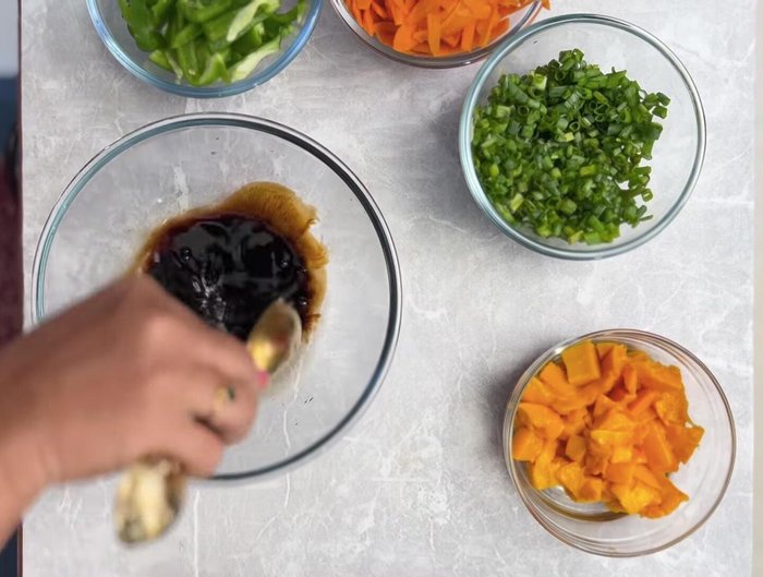 Prepare salad: Mix vegetables with soy sauce, rice vinegar (or apple cider vinegar), garlic, ginger, honey/sugar, and oil.