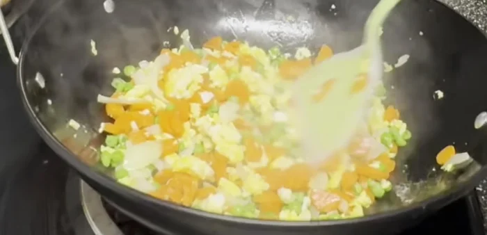 Add leftover rice and salt to taste. Stir everything together.