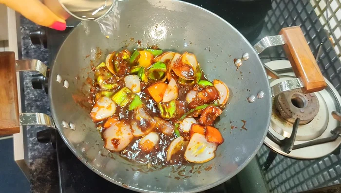 Mix in the Kashmiri red chilli powder paste, adding a little more water to adjust the consistency. Add vinegar and salt (carefully, as salt was added previously).