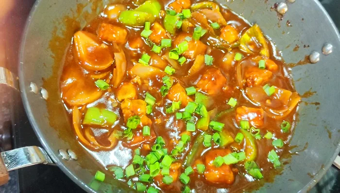 Garnish with spring onion and serve hot.