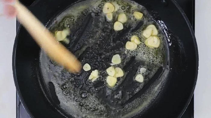 Add garlic (and shallots, if using) to the hot oil. The garlic should sizzle. This is where the aroma magic happens!