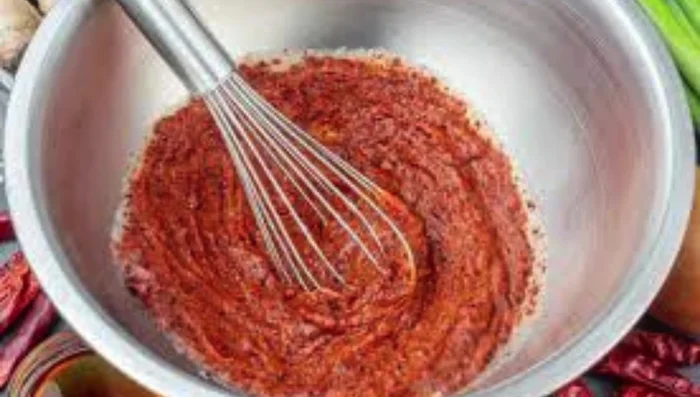 In a separate bowl, mix your chili flakes with a bit of salt and sugar. This helps blend the flavors.