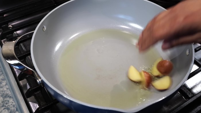 Heat oil over medium-high heat. Add minced potatoes and carrots. Fry until potatoes are slightly golden brown.