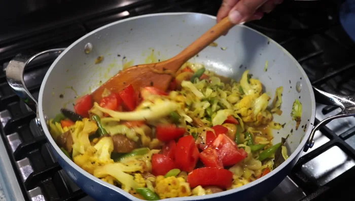 Add chopped tomatoes (and fresh green peas if using). Cover and cook for 3-4 minutes until vegetables are tender but not mushy.