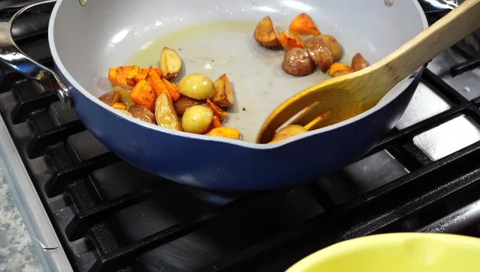 Remove potatoes and carrots. Add cauliflower to the pan and fry until light golden brown.