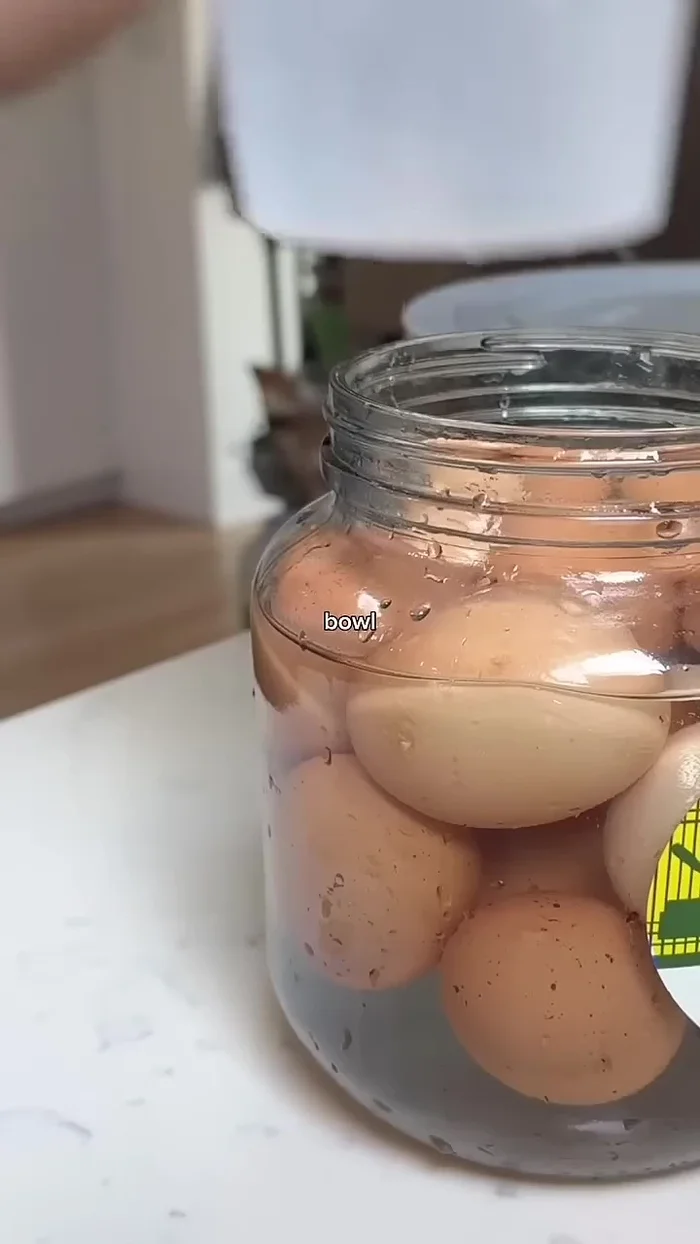 Put something heavy (a plate or a water-filled container) on top of the eggs to submerge them in the brine.