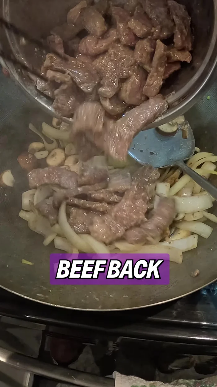 Return the beef to the pan. Add the white parts of the green onions and stir.