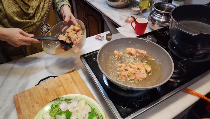 Shallow fry the marinated chicken in the same pan until lightly browned, stirring to ensure even cooking. Set aside.