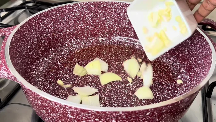 Sauté vegetables: Remove the fried chicken. Remove most of the oil from the pot, leaving a bit. Add garlic, onion, and bell peppers; sauté for about a minute. Add pineapple pieces and sauté.