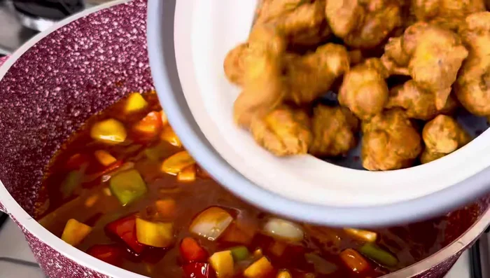 Combine and simmer: Add the sweet and sour sauce to the pot with the sautéed vegetables. Add the fried chicken pieces, ensuring they are well coated in the sauce. Simmer until heated through.