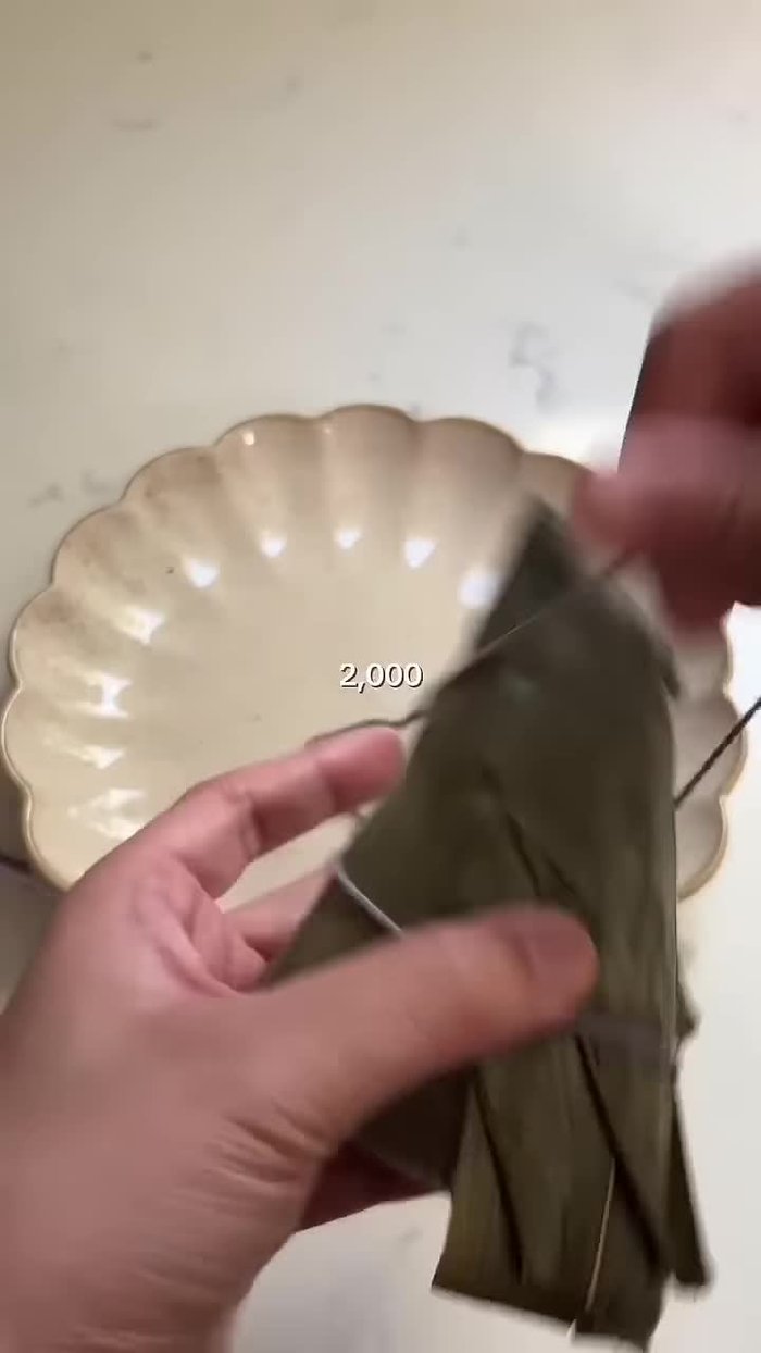 Assemble the Zongzi: Fold the bamboo leaves into a cone shape or other desired form. Place a spoonful of sticky rice, then the filling, and then more sticky rice inside the leaf.