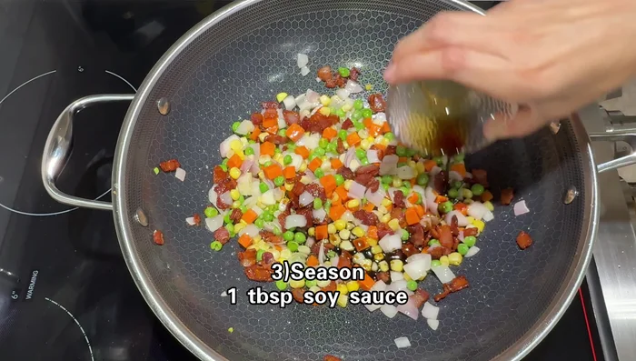 Add soy sauce (1 tbsp), sugar (1/2 tsp), white pepper, chicken bouillon powder, and oyster sauce (1 tbsp). Mix well.