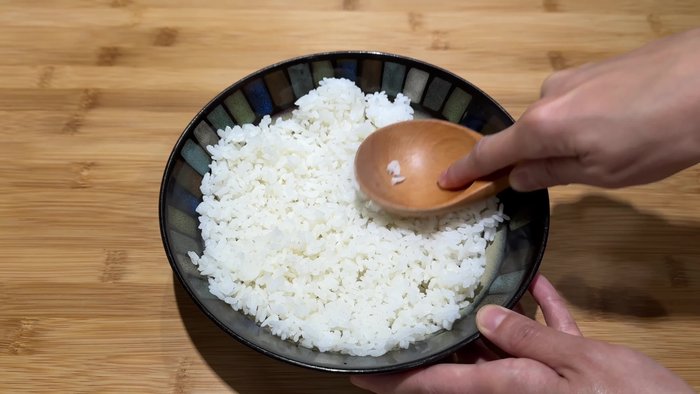 Break apart leftover rice with a spoon to ensure even frying and fluffiness.