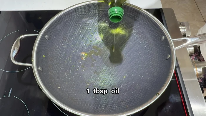 Add oil to the wok and scramble eggs until almost cooked but still slightly soft.