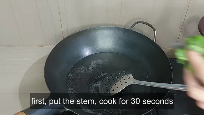 Boil water in a pan, add salt, and blanch the kale stems for 30 seconds, followed by the leaves for another 30 seconds. Add 1 tablespoon of vegetable oil to maintain color and crispness.