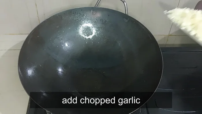 Add the chopped garlic to the pan until fragrant. Then, pour in the prepared sauce.