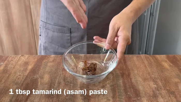 Prepare tamarind water: Mix tamarind with hot water, let it soak, then strain. (63.44)