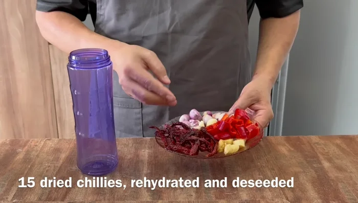 Prepare rampa paste: Blend rehydrated chilies, ginger, red chilies, garlic, shallots, and oil (or water). (86.64)