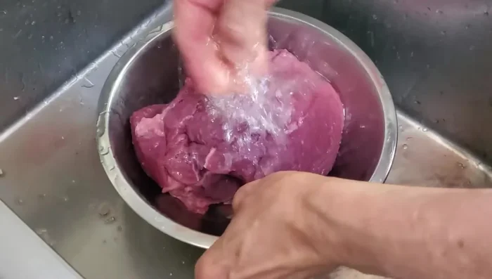 Rinse the beef to remove excess blood. Cut the beef against the grain into small bite-sized pieces.