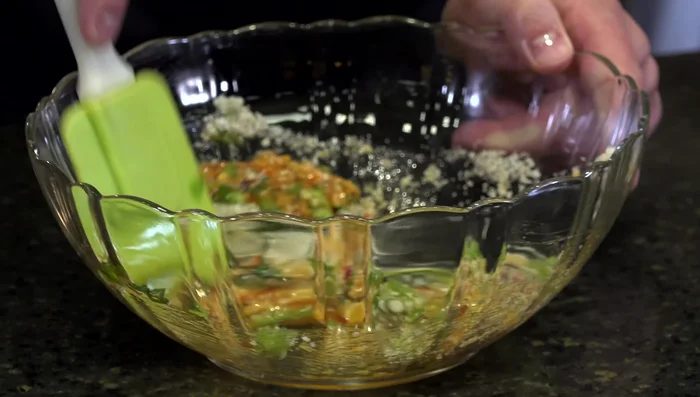 Once the pike is cooked, break it into smaller pieces and mix it with the ingredient mixture.