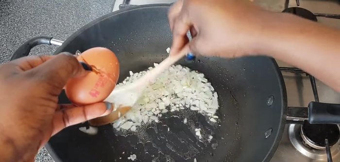 Move the onion to one side, and add the eggs to the other side of the wok. Season with salt and pepper.